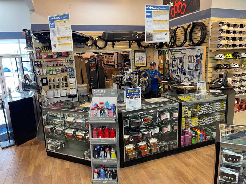 Wall of skis and ski boots at a Sun & Ski Sports shop in Phoenix, Arizona.